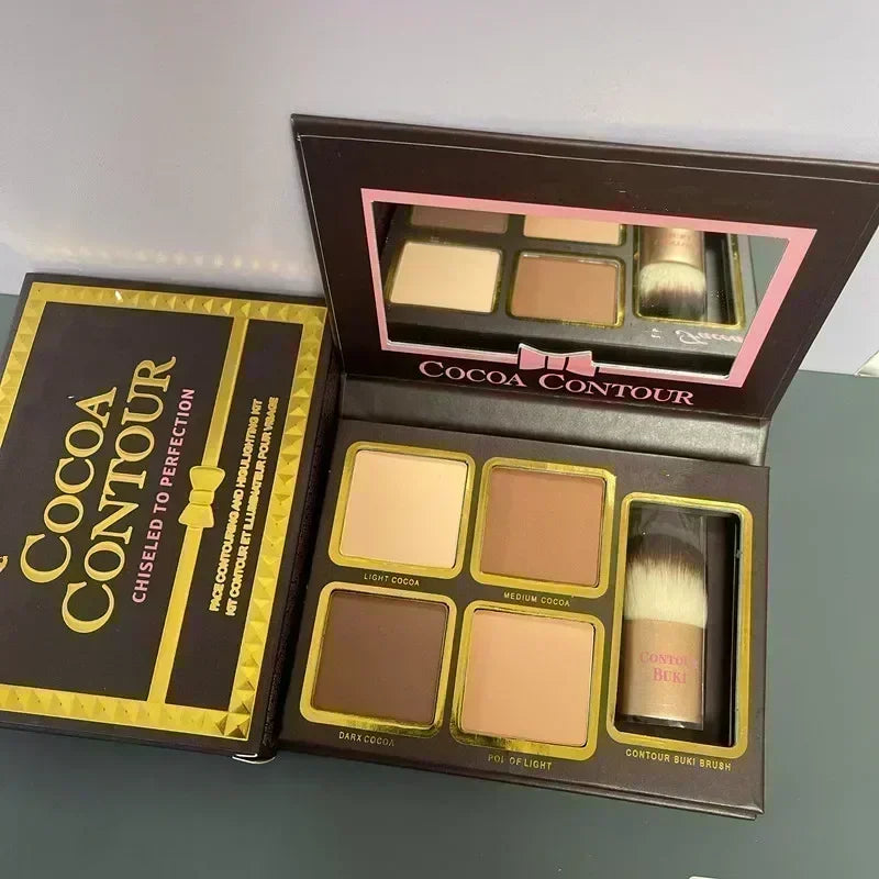 Cocoa contour makeup palette with brush and packaging on a gray surface