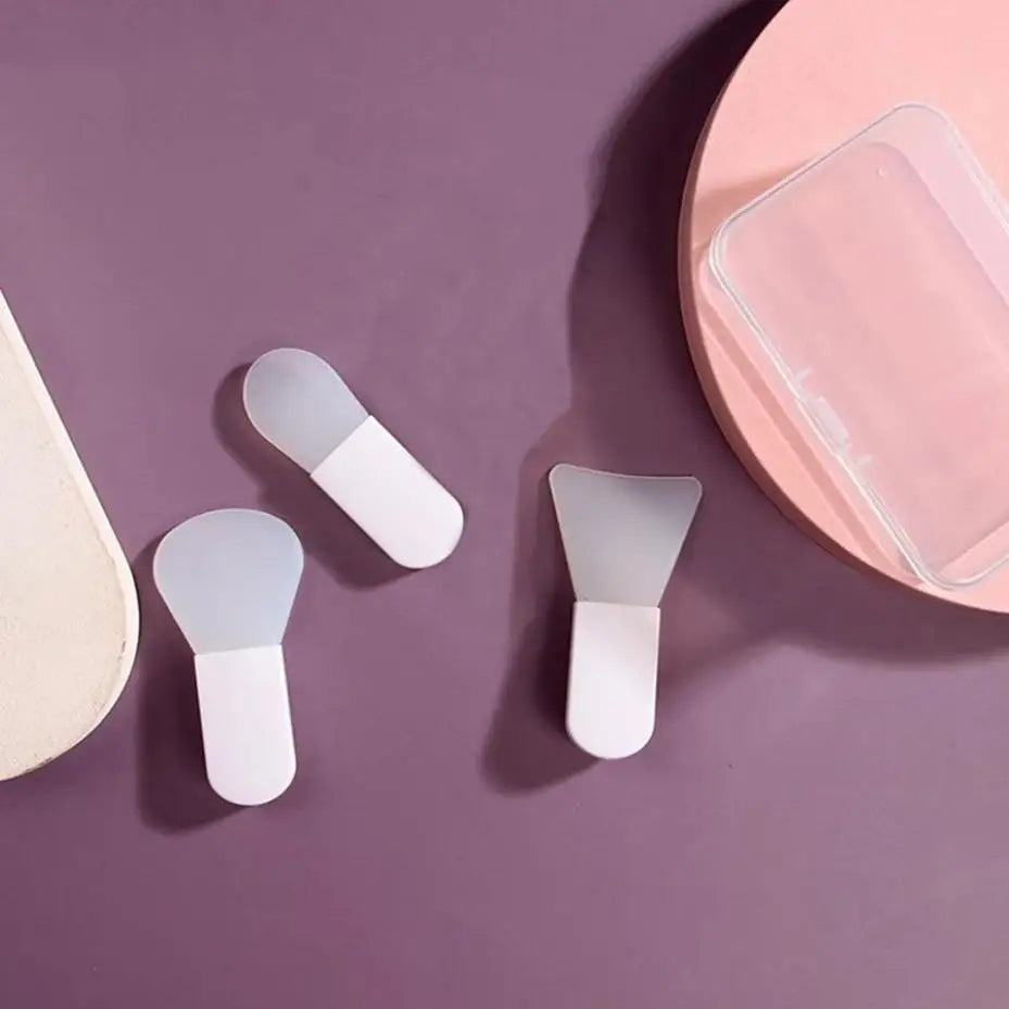 Three small scoops on a purple surface with a pink container in the background.