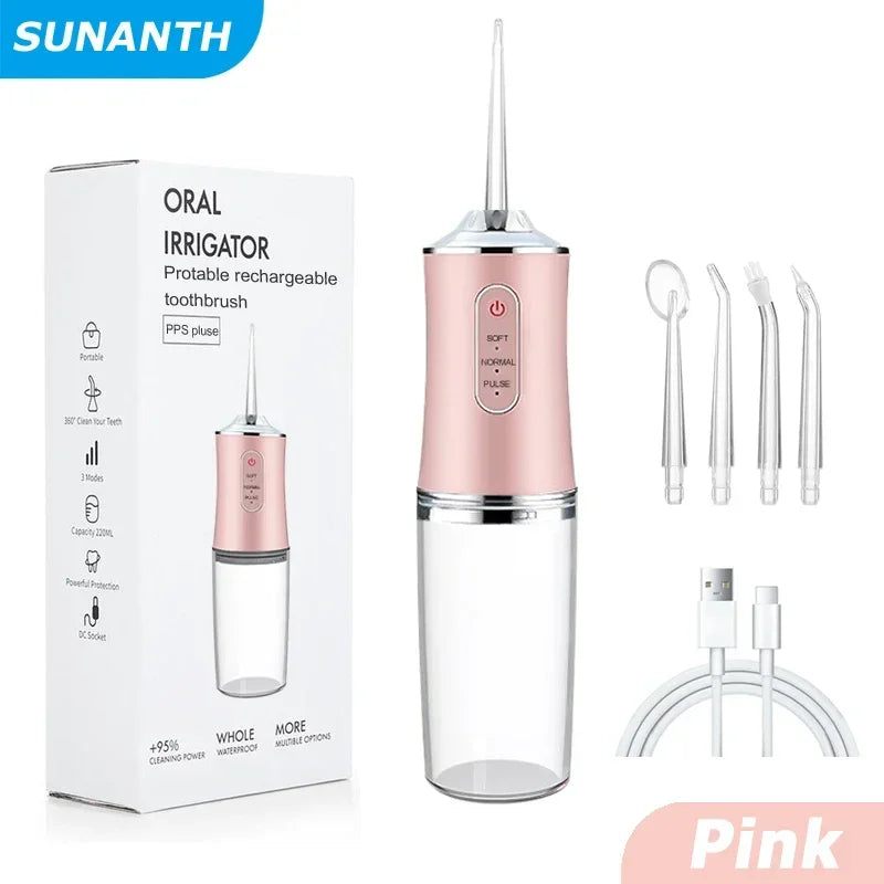 Pink oral irrigator with packaging, nozzles, and charging cable on a white background