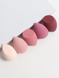 Set of pink and red makeup sponges on a white background