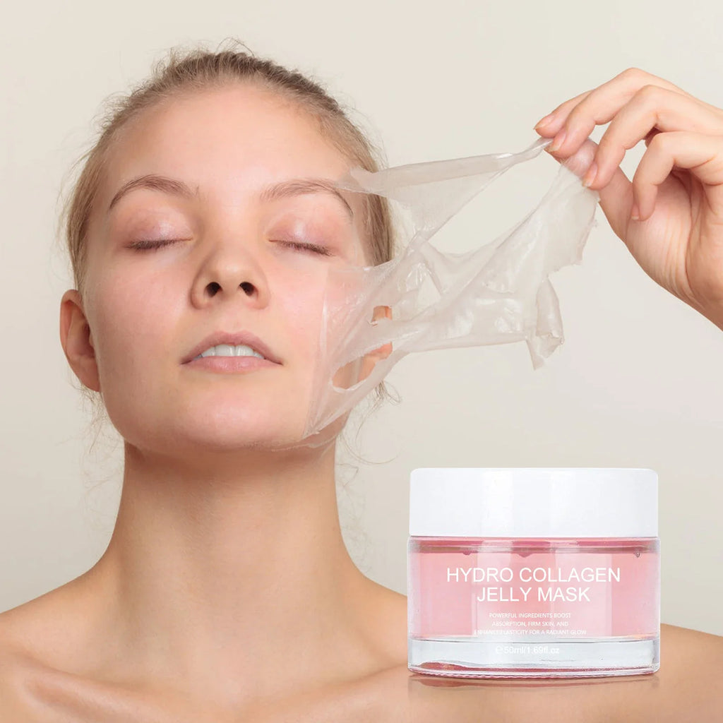 A woman with her eyes closed is peeling a translucent hydro collagen jelly mask from her face, with a jar of pink-colored hydro collagen jelly mask in the foreground against a light beige background.