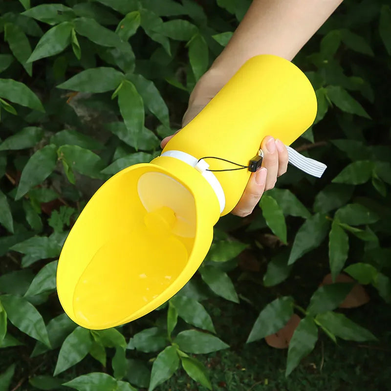 Yellow plastic funnel held by a hand against a green leafy background