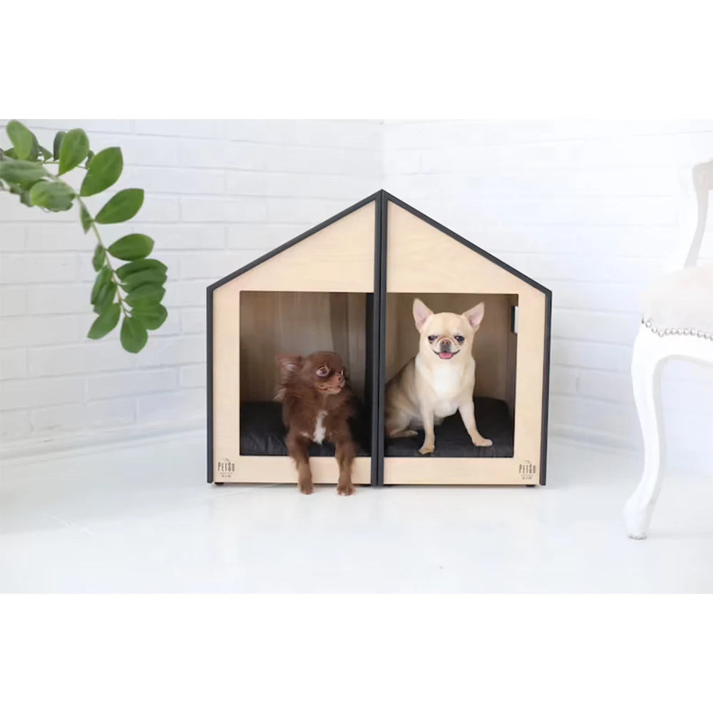 Two small dogs inside a modern wooden pet house with a white background.
