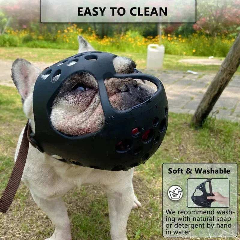 A white French bulldog wearing a black muzzle-style protective helmet outdoors on grass, with text overlays reading 'EASY TO CLEAN' and 'Soft & Washable' plus a small demonstration inset.