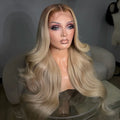 Long, wavy blonde wig with a center part and realistic hair texture, displayed on a mannequin bust in an indoor setting.