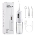 Portable water flosser with packaging, nozzles, and USB cable on a white background