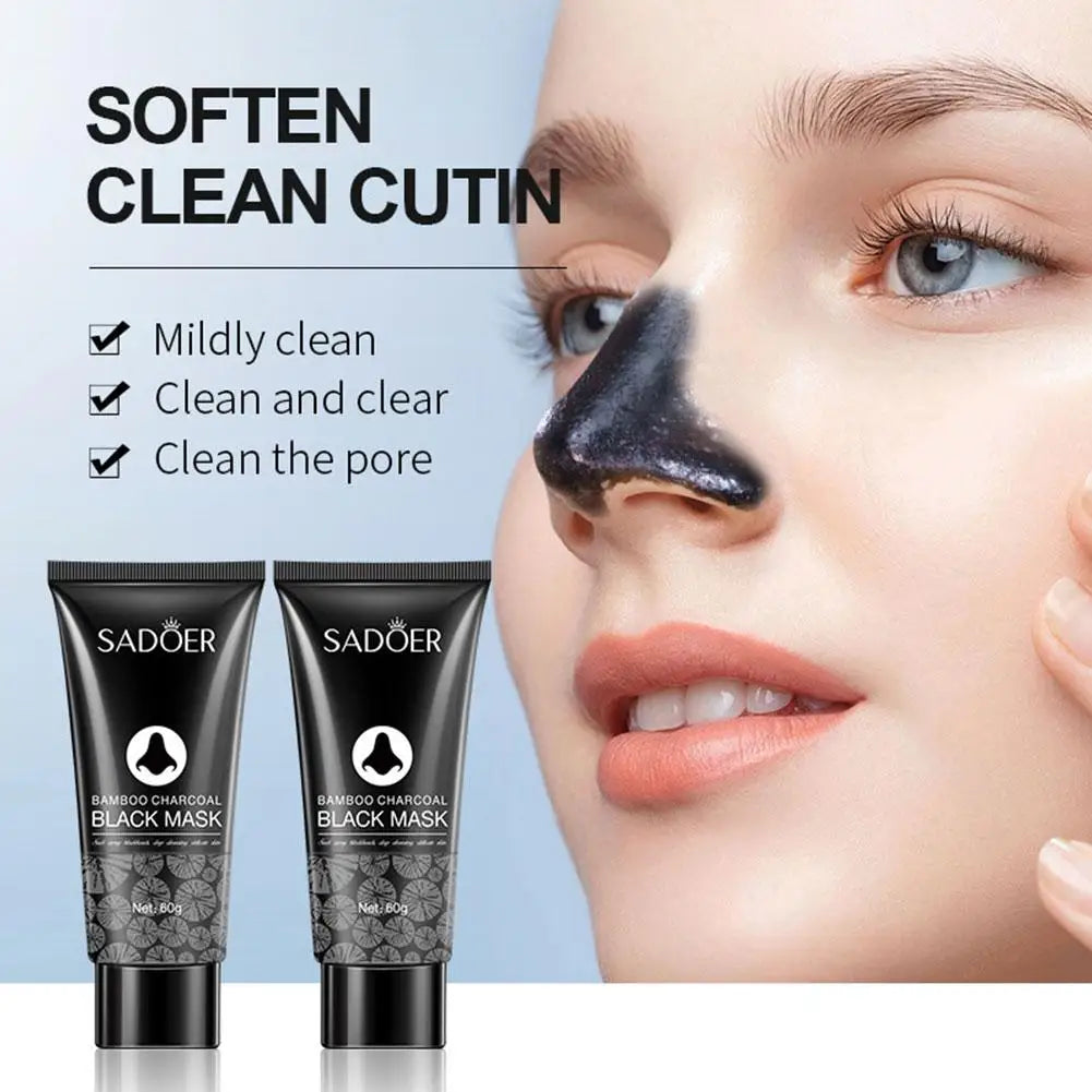 Woman applying black face mask with SADOER black mask tubes on a light blue background