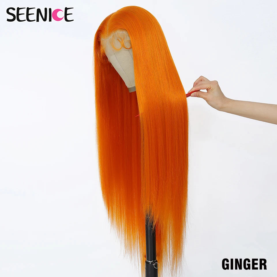 A long, straight orange wig displayed on a mannequin head stand against a white background, with a hand holding a small orange object near the hair. The brand name 'SEENICE' appears in the top left, and 'GINGER' is written in the bottom right.