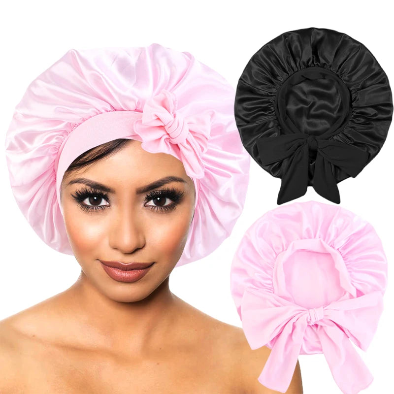 Woman wearing a pink satin bonnet with additional black and pink bonnets displayed.