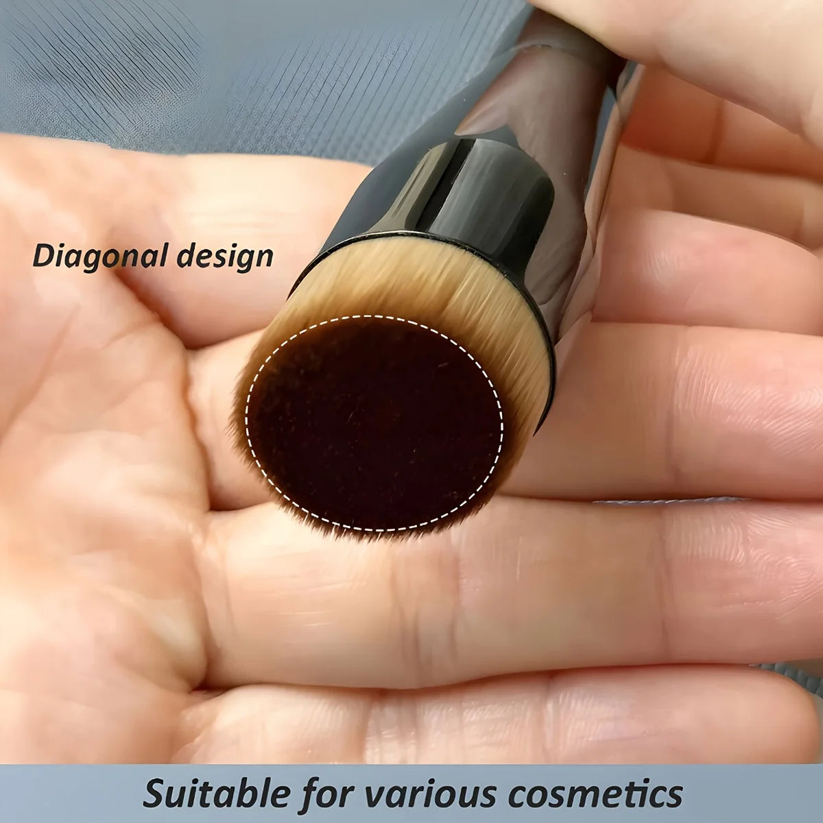 Makeup brush with diagonal design held in hand, suitable for various cosmetics.