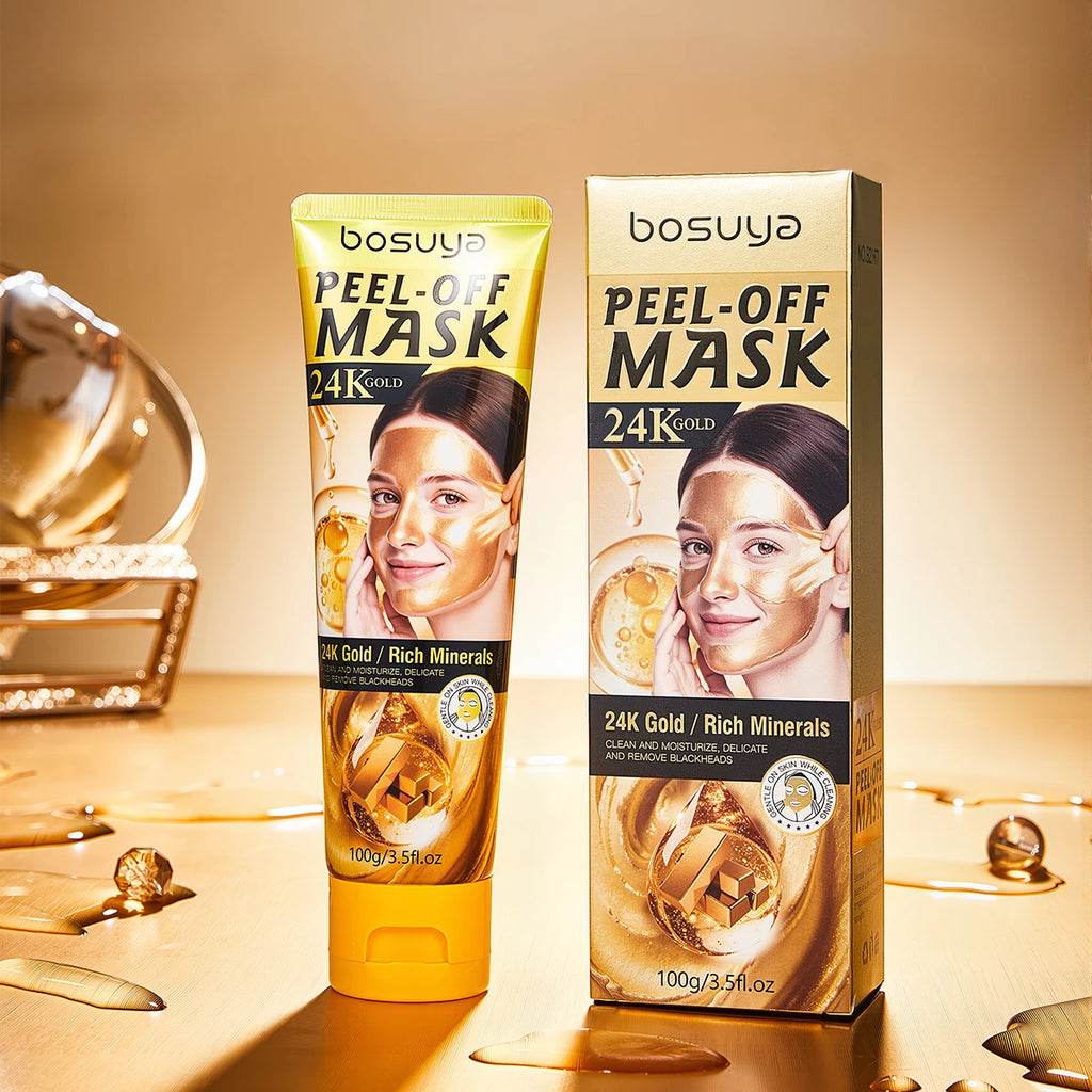 bosuya Peel-Off Mask 24K Gold tube and matching box displayed on a warm beige surface with decorative gold liquid and metallic props. The packaging features a woman applying a gold mask, with text highlighting rich minerals and 24K gold.