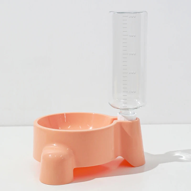 Pink pet feeder with a clear water bottle on a white background
