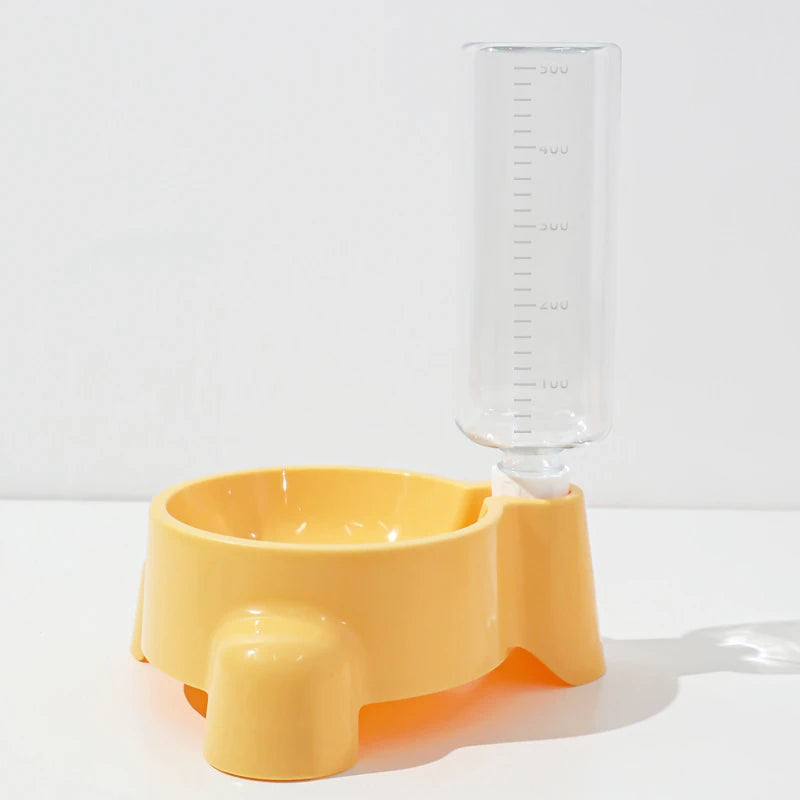 Yellow pet feeder with a clear water bottle on a white background