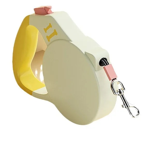 Retractable dog leash with yellow and beige design on a white background