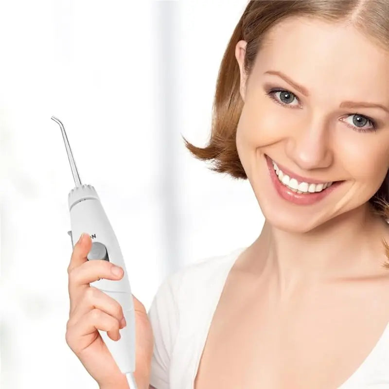 Woman holding a dental water flosser with a white background