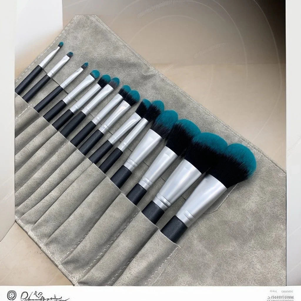 A 14-piece makeup brush set with black and silver handles and teal bristles, displayed in a gray suede roll-up case.