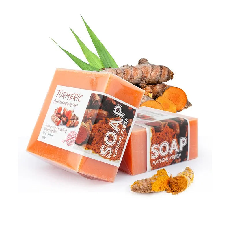 Turmeric soap with turmeric roots and leaves on a white background