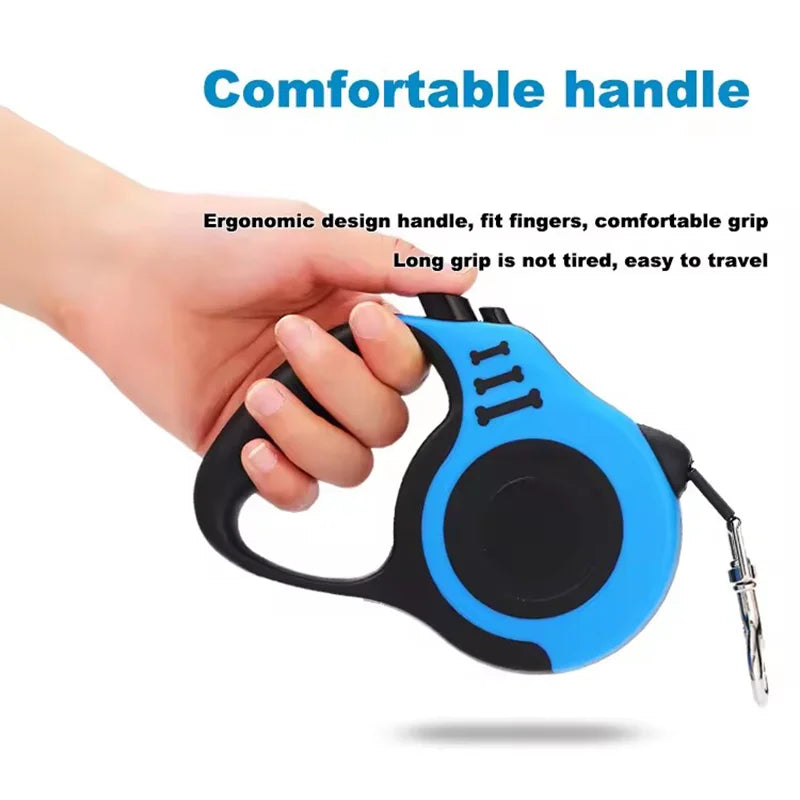 Blue and black retractable dog leash with ergonomic handle held by a hand on a white background