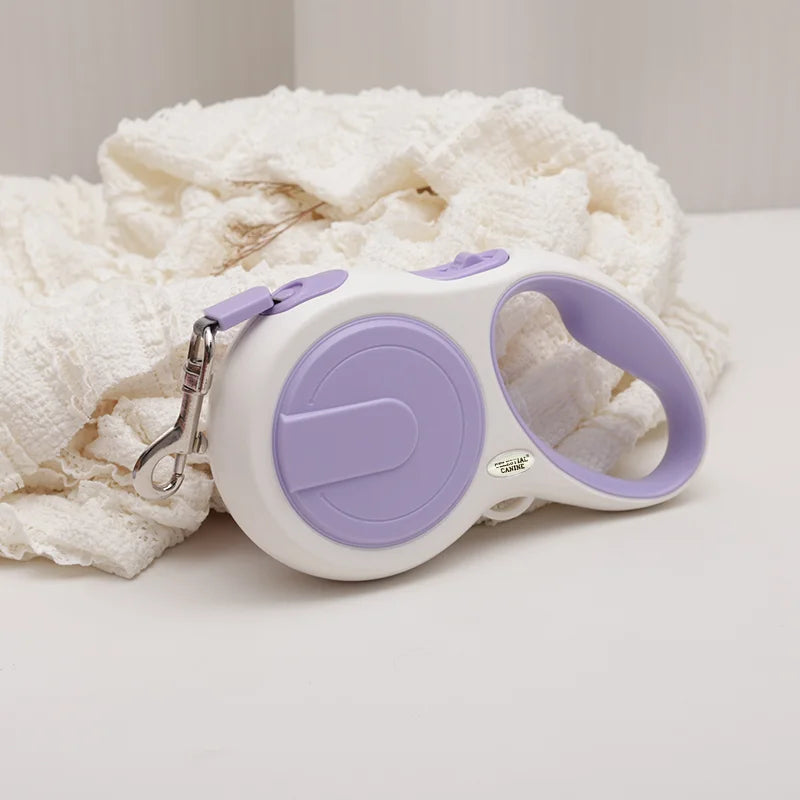Retractable dog leash with purple handle and white body on a light background