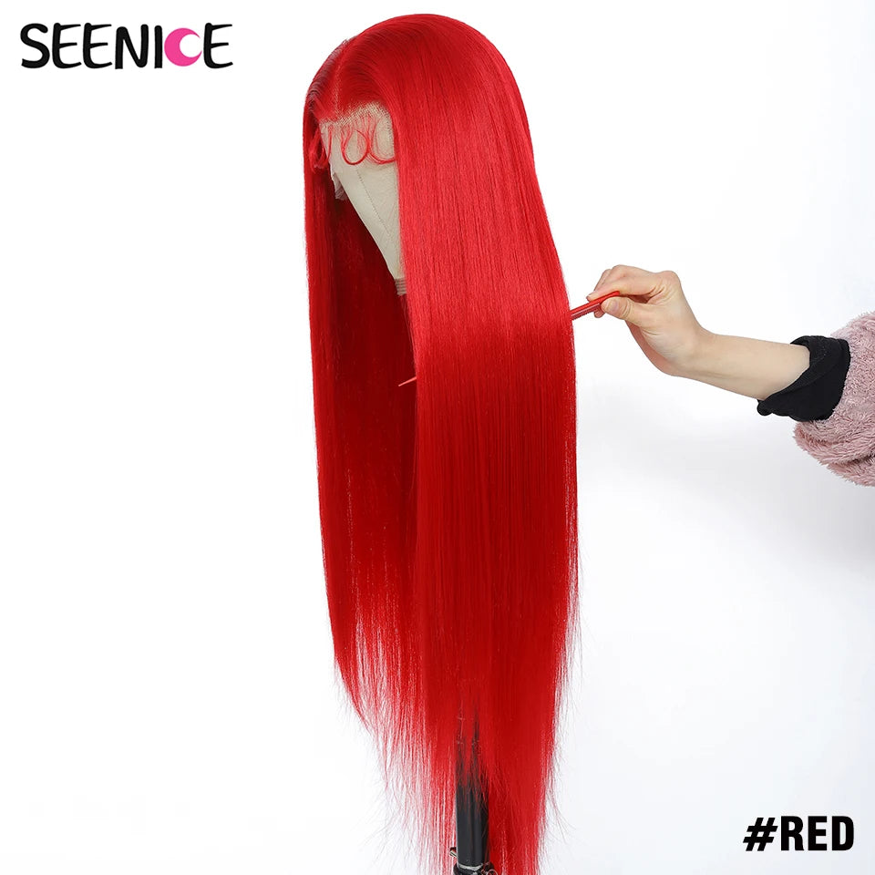 A bright red straight wig displayed on a mannequin head stand, with a hand adjusting the hair. The brand name 'SEENICE' is visible in the top left corner, and '#RED' is written in the bottom right.