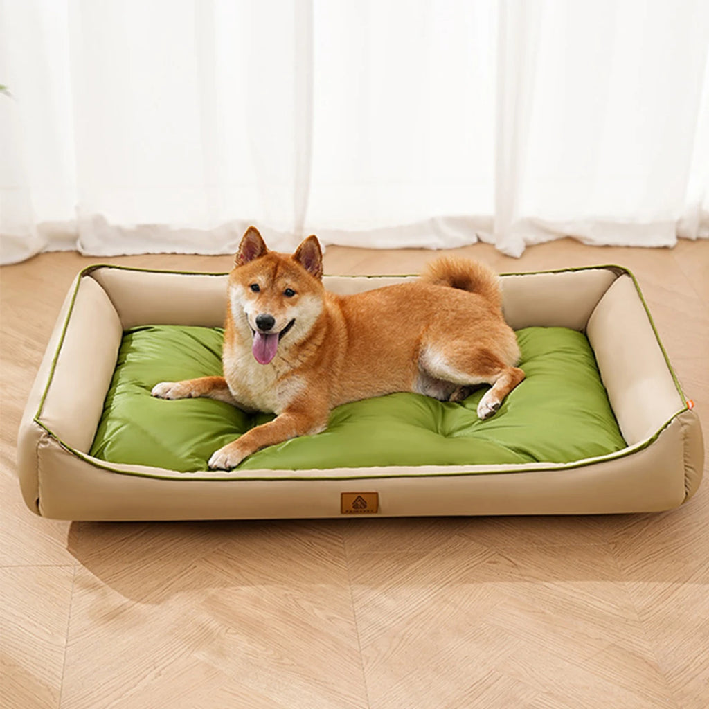 Dog lying on a green and beige pet bed with a white curtain background
