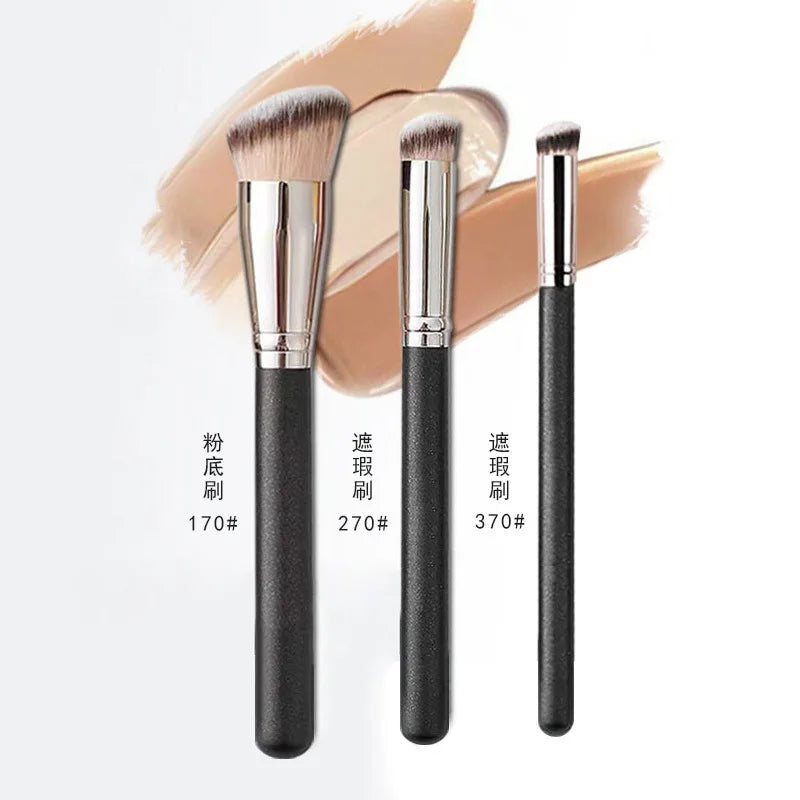 Three makeup brushes with black handles and silver ferrules on a white background.