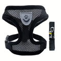 Black and gray dog harness with a matching leash on a white background