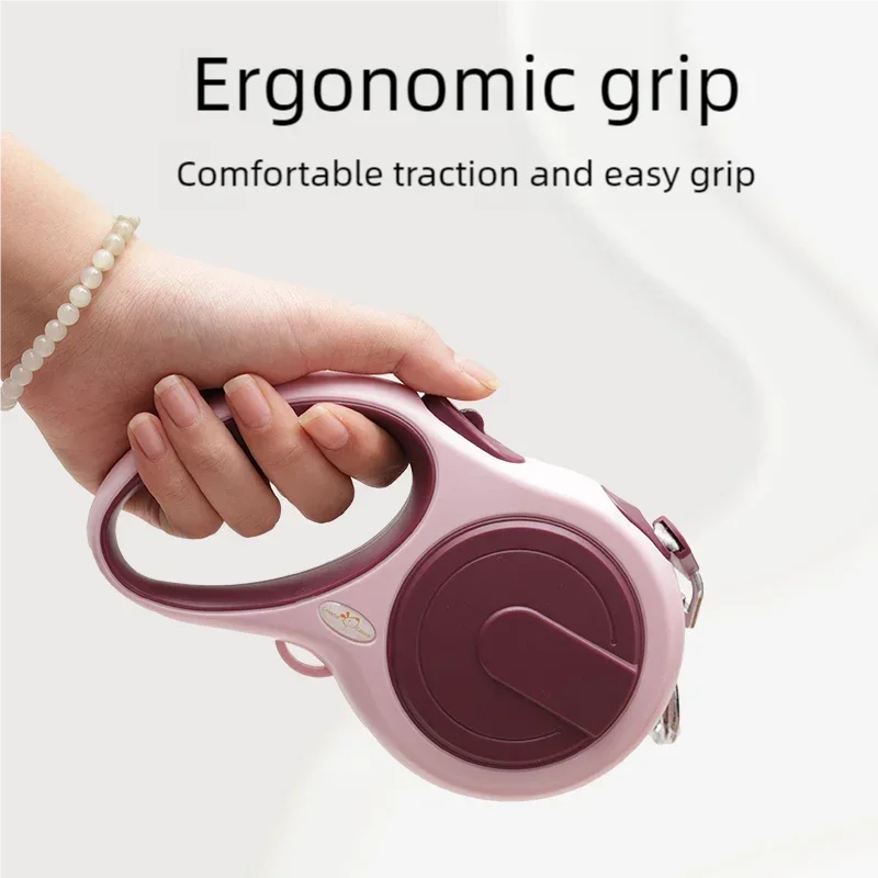 Pink retractable dog leash with ergonomic grip on a white background