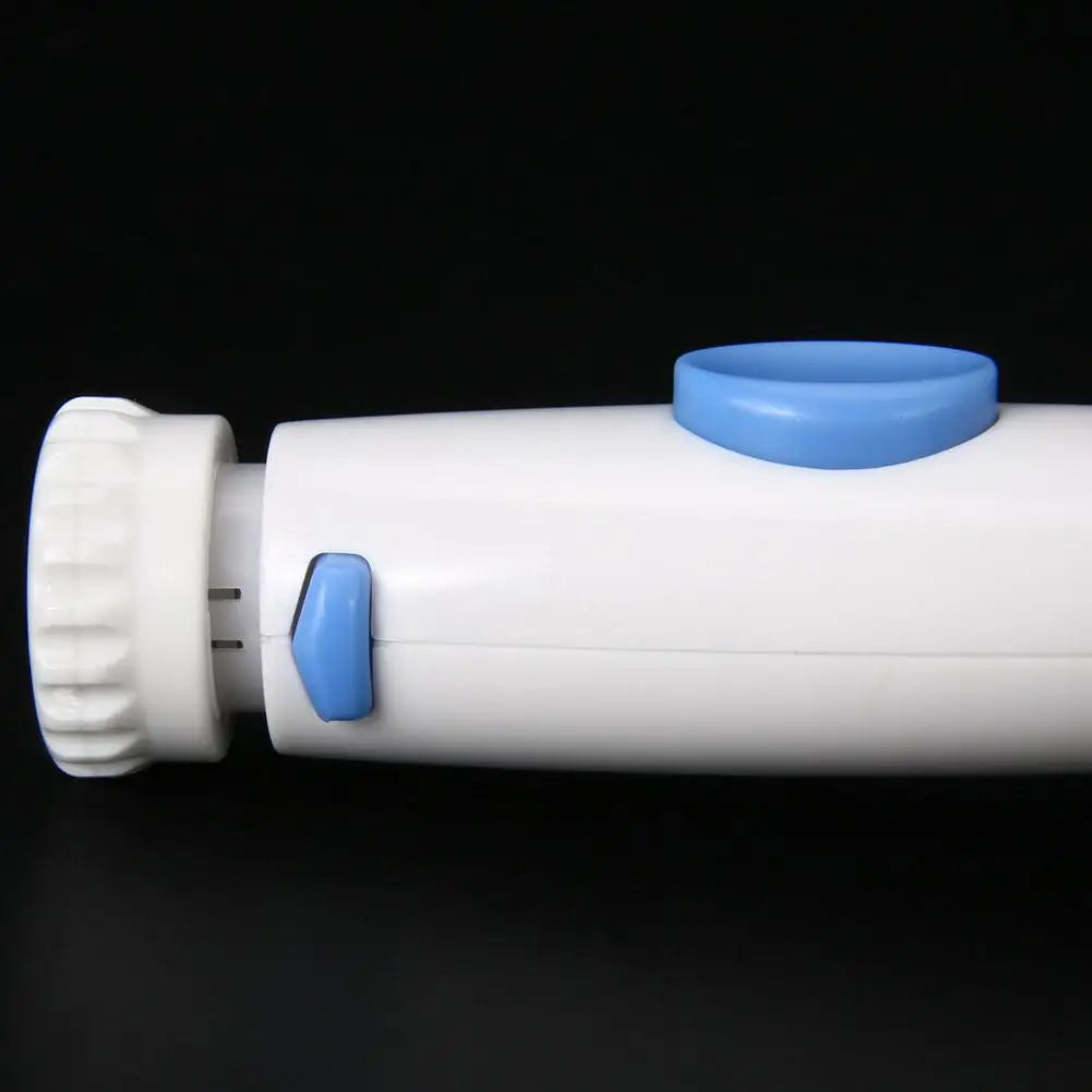 A close-up of a white cylindrical handheld device with blue accents, including a blue button on top and a blue side switch, set against a solid black background.