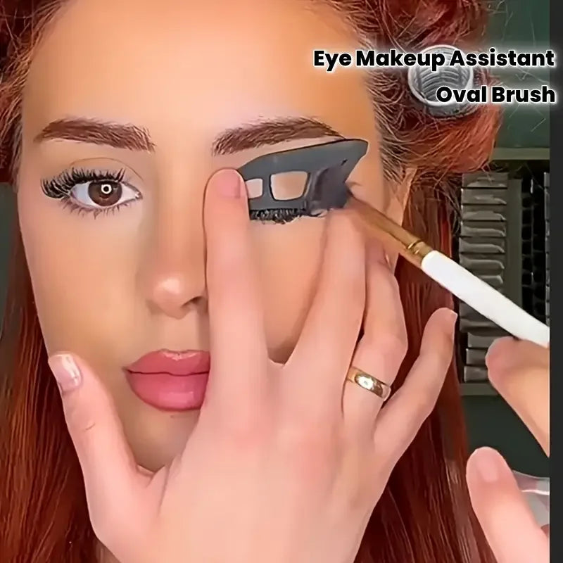 Person applying makeup with an oval brush, focusing on eye makeup.
