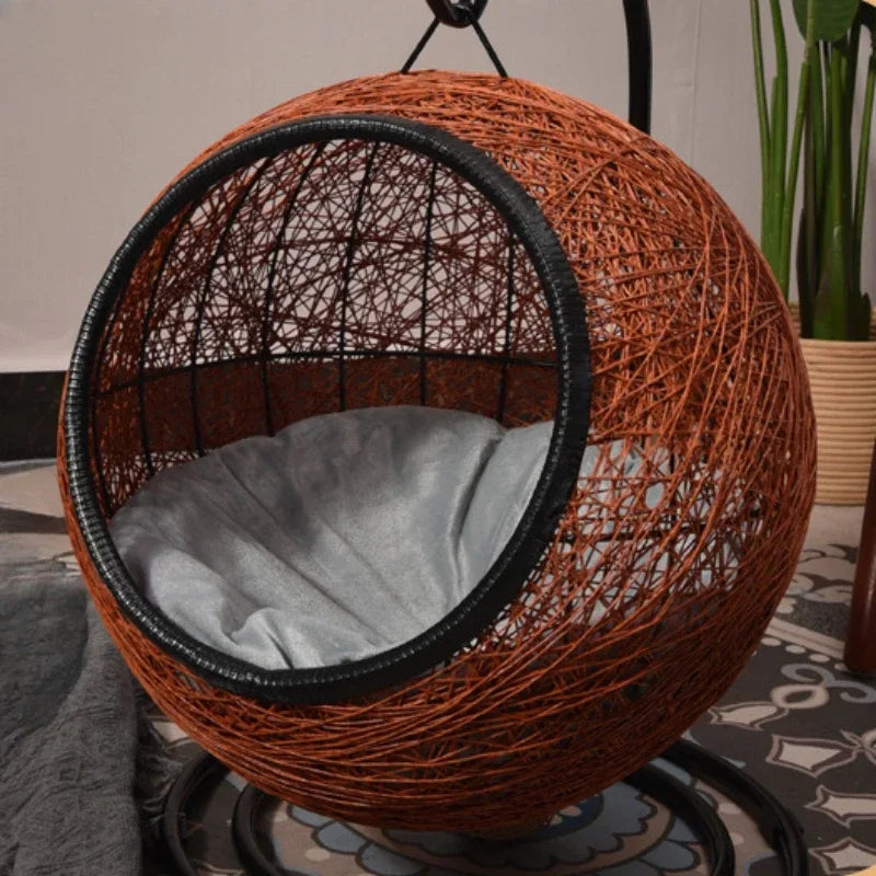 Wicker egg chair with a cushion on a patterned floor