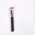 Makeup brush with black handle and silver ferrule on a white background