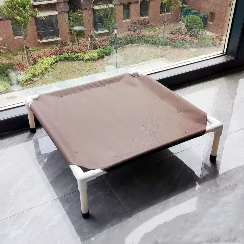 Brown pet bed on a stand in front of a window with a garden view