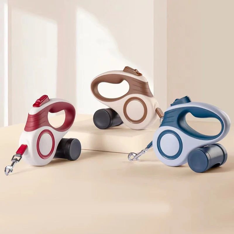 Three retractable dog leashes in different colors on a white background