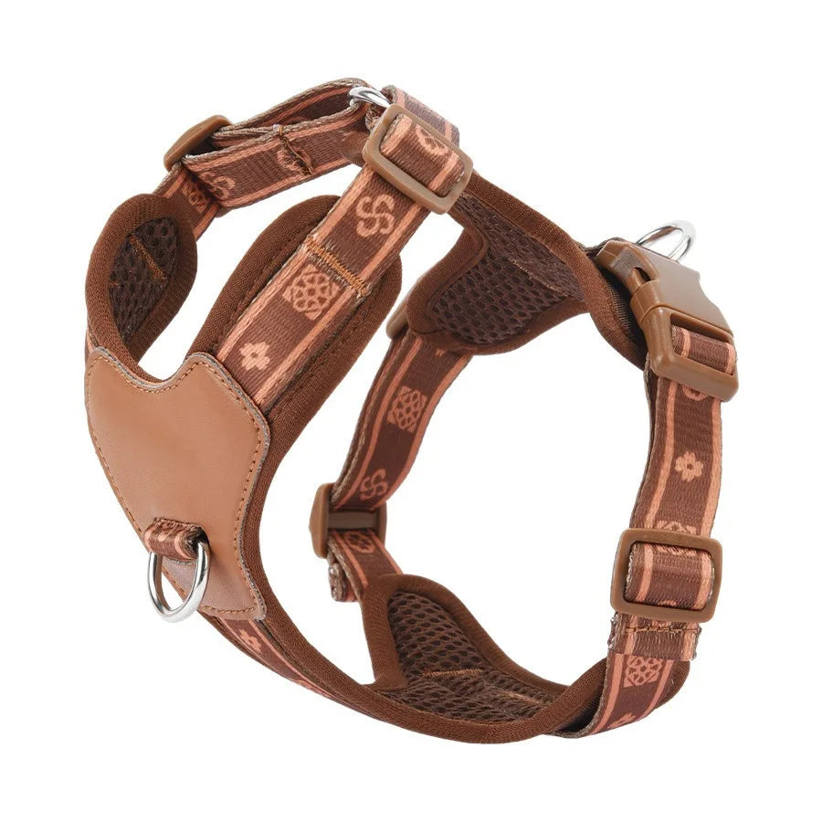 Brown dog harness with intricate patterns on a white background