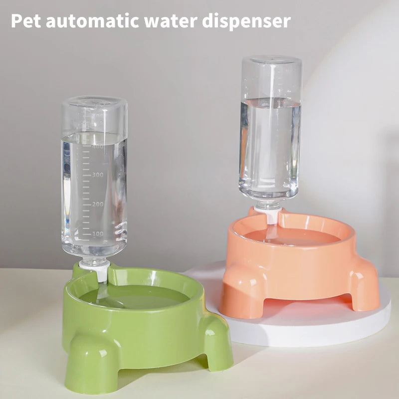 Pet automatic water dispenser with green and pink bases on a white surface.