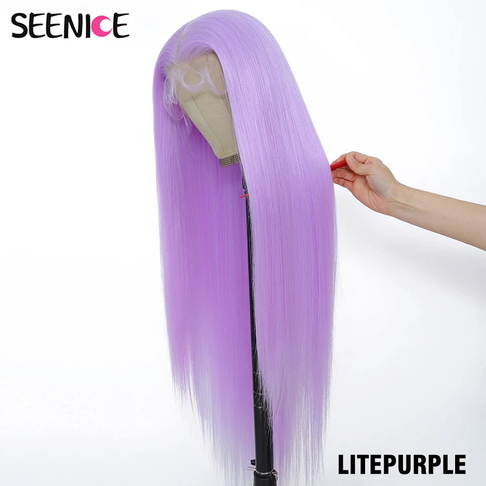 A long, straight wig in light purple color displayed on a mannequin head stand, with a human hand holding a section of the hair to show its texture and weight. The brand name 'SEENICE' is visible in the top left corner, and 'LITEPURPLE' is written in the bottom right corner.