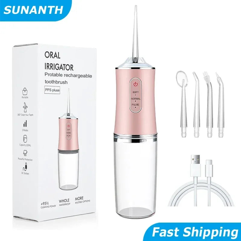 Pink oral irrigator with packaging and accessories on a white background