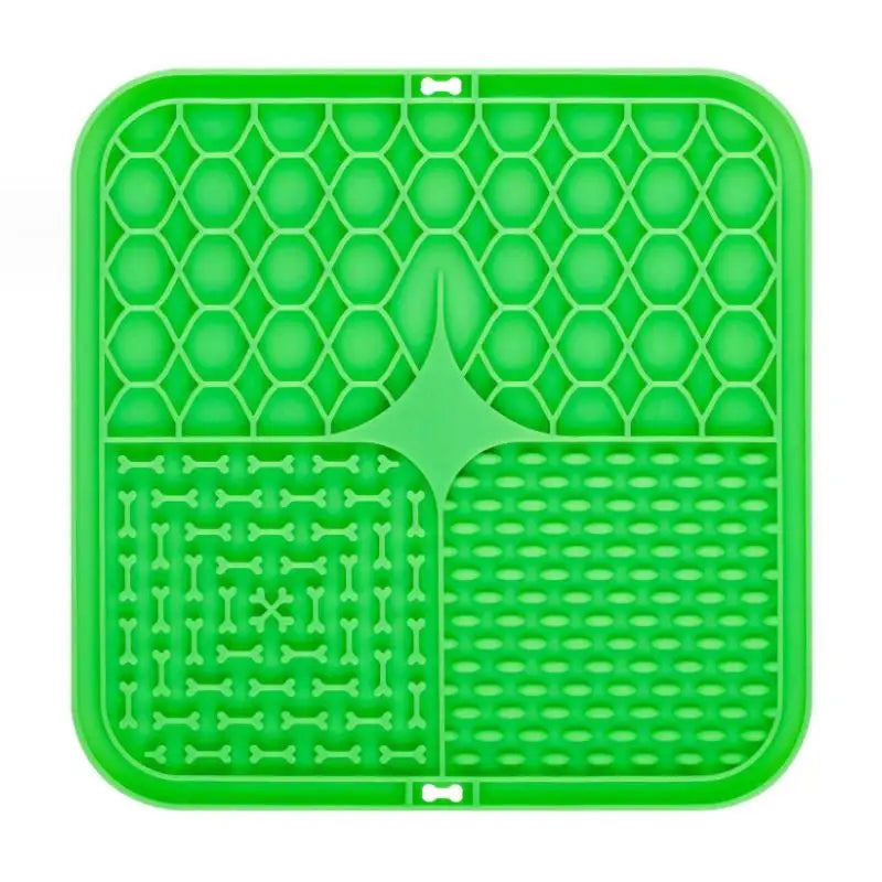 Green silicone mat with bone and bow tie patterns on a white background