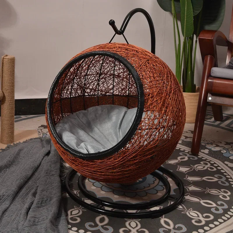 Woven pet bed on a stand in a room with a patterned rug and plant.