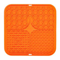 Orange silicone mat with textured design on a white background