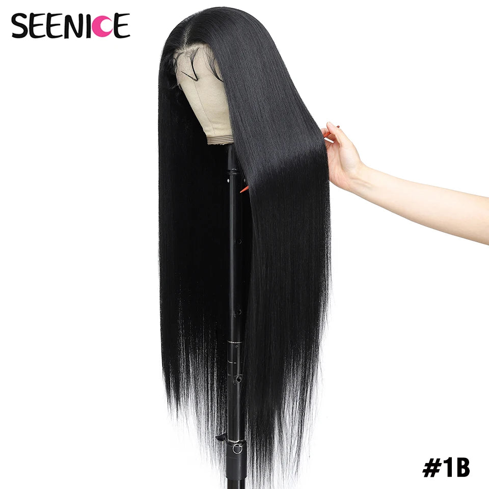 A long, straight black wig displayed on a mannequin stand against a white background, with a hand holding a section of the hair to show texture and length. The brand name 'SEENICE' is visible in the top left corner, and the shade '#1B' is shown in the bottom right.