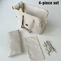 4-piece set of bags including a large beige bag, a smaller beige bag, a checkered mat, and a strap on a white background.