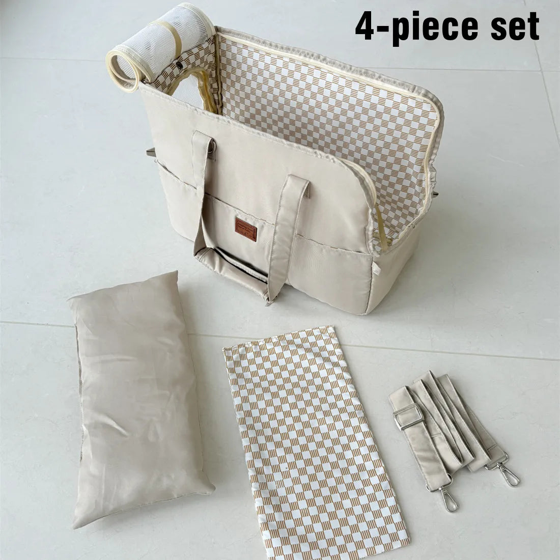 4-piece set of bags including a large beige bag, a smaller beige bag, a checkered mat, and a strap on a white background.