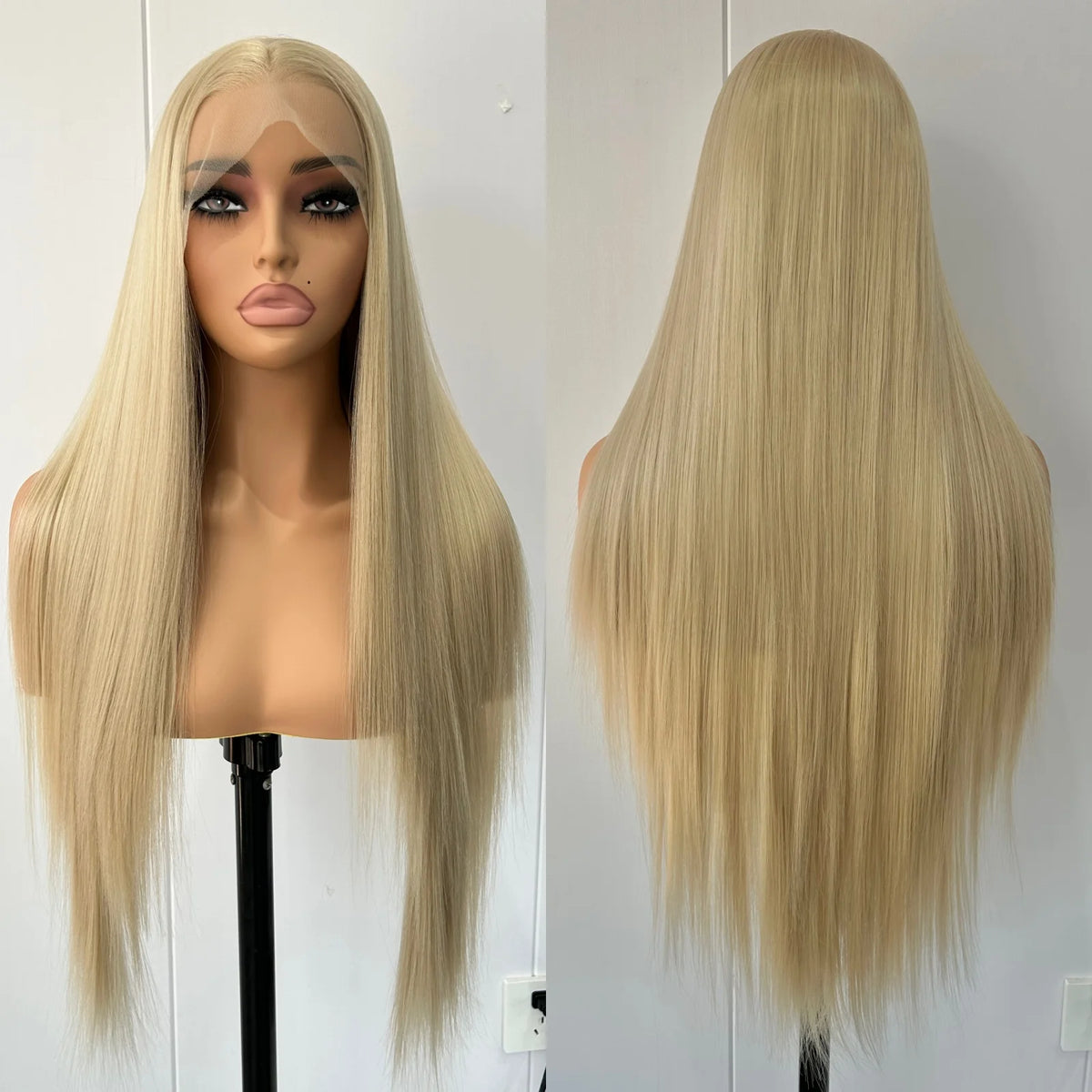 A long straight wig displayed on a mannequin head and stand, with a front view on the left and a back view on the right, against a plain indoor wall.