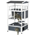 A multi-level cat house with a white frame and dark gray panels, shown on a white background with two cats using the structure.