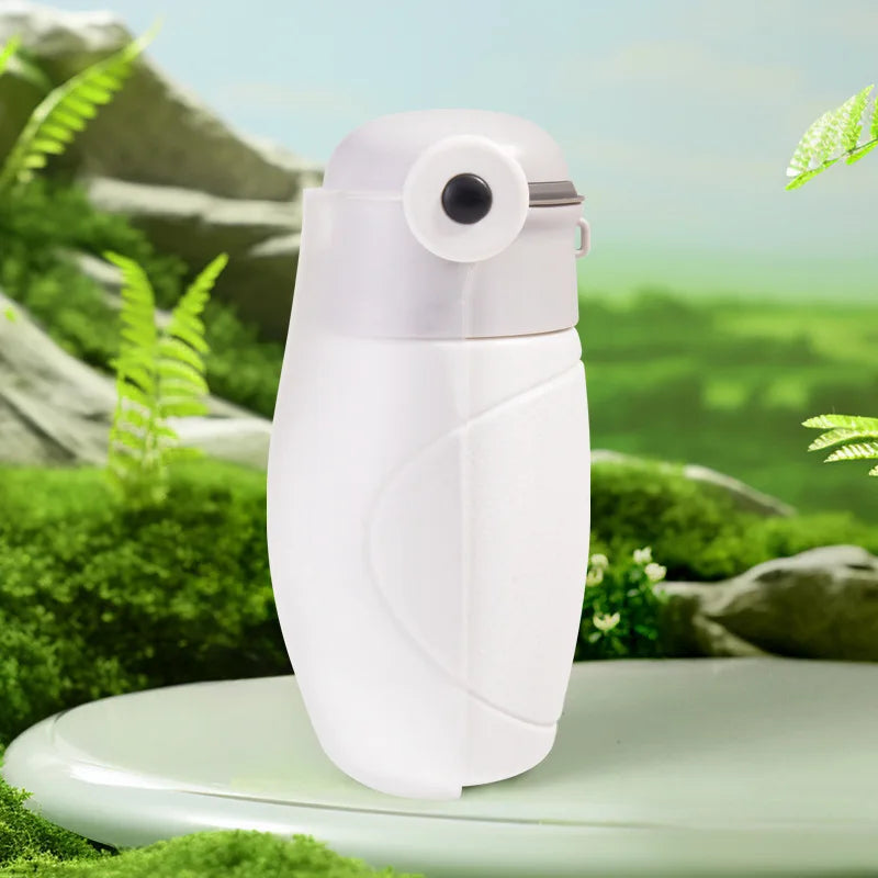 White spray bottle with a natural green background