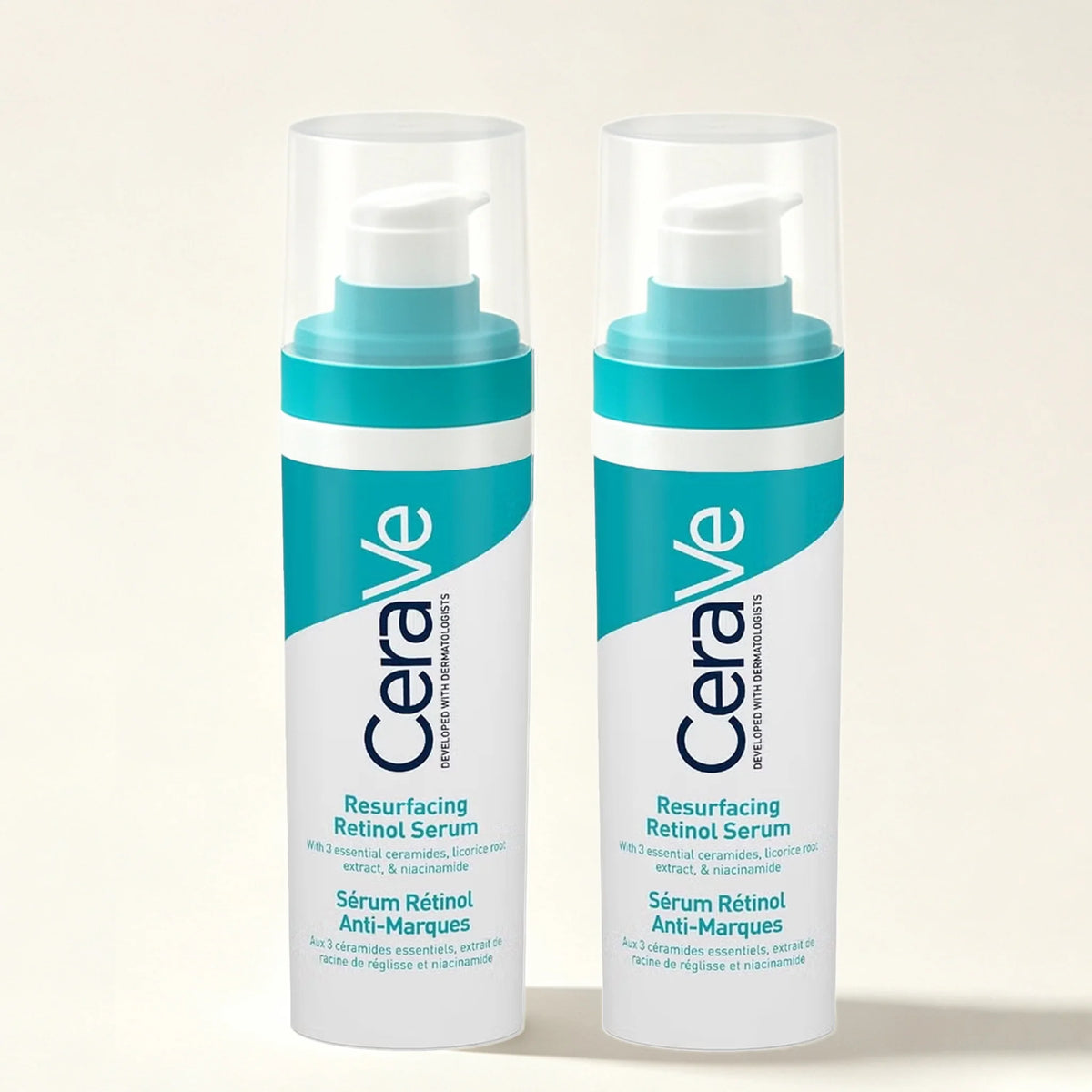 Two bottles of CeraVe Resurfacing Retinol Serum standing side by side on a light beige background.