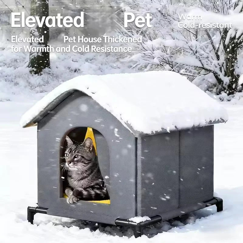 Gray elevated pet house with a cat peeking out in a snowy outdoor setting