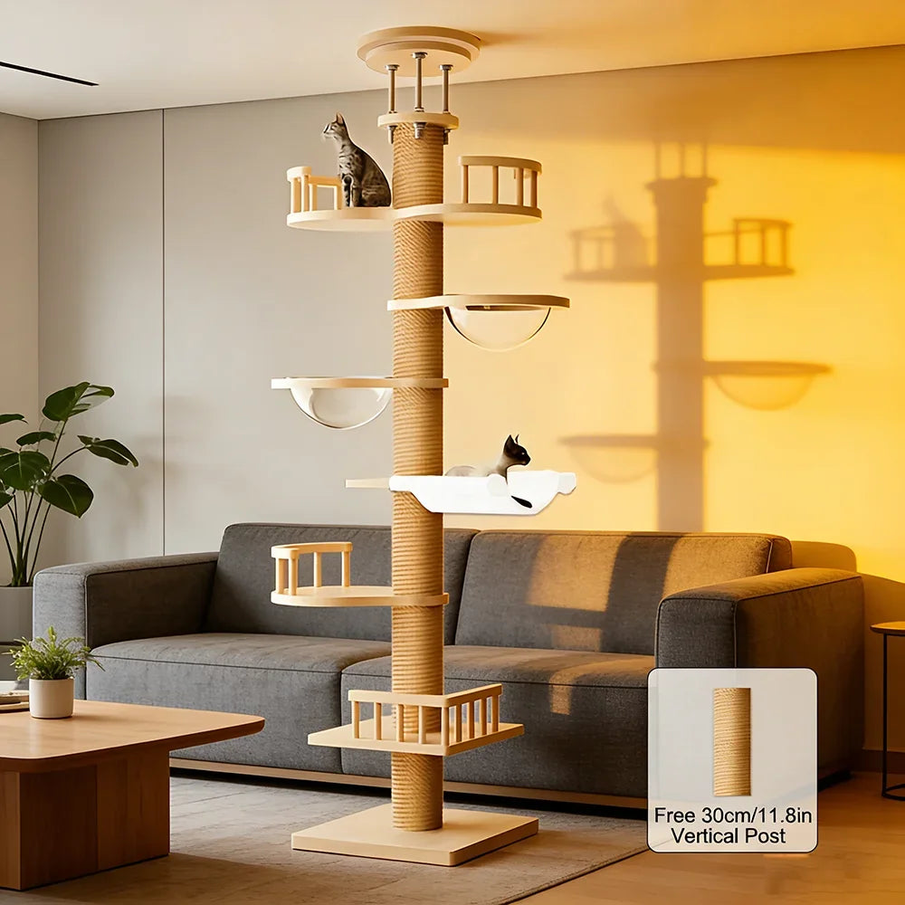 Cat tree in a living room with a gray sofa and a plant.